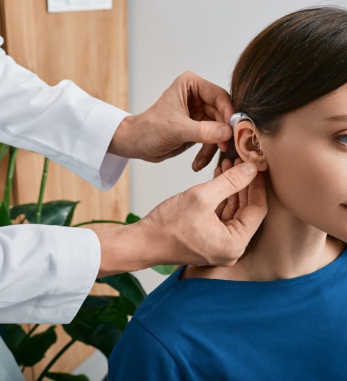 Installation,Hearing,Aid,On,Woman's,Ear,At,Hearing,Clinic,,Close-up,